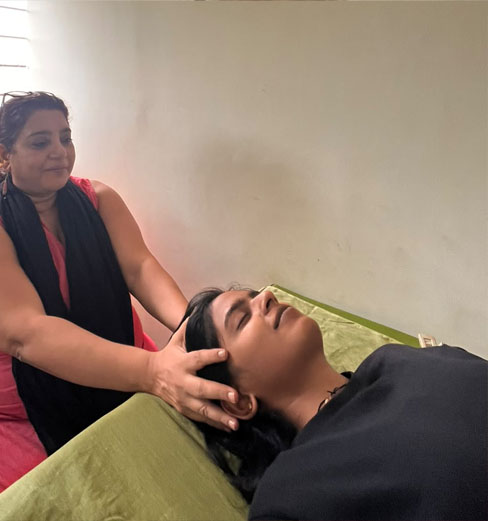 Vidhya giving a CranioSacral Therapy session with light touch at the head